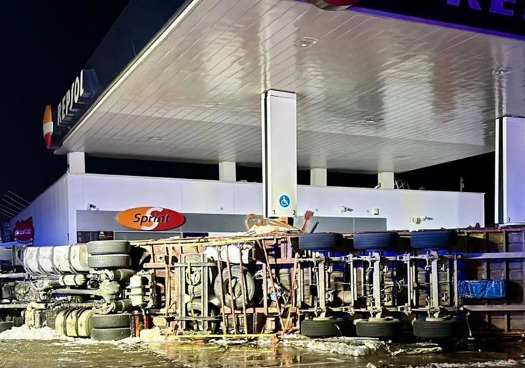 Image of the crashed lorry on the fuel station forecourt.