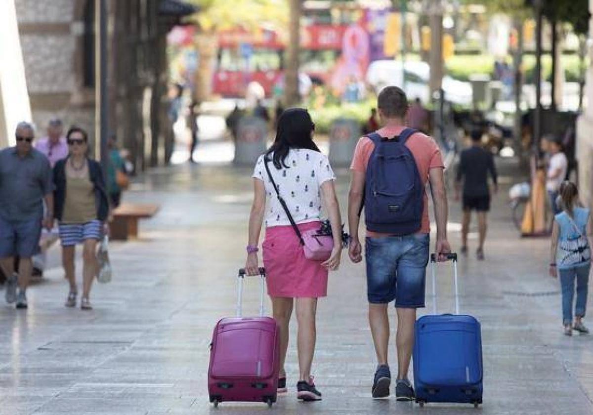 File image of tourists wheeling suitcases.