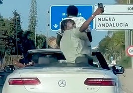 Watch as passengers in two convertibles take 'selfies' standing up while cars speed along Costa del Sol motorway