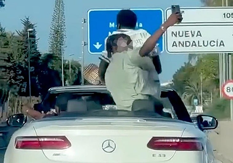 Watch as passengers in two convertibles take 'selfies' standing up while cars speed along Costa del Sol motorway
