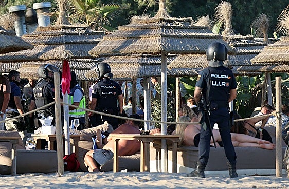 This is the moment around 50 police officers raided a popular beach club in Marbella at the weekend