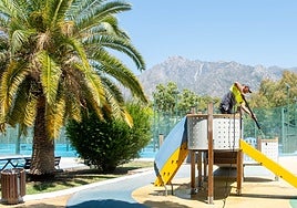 Workers clean the children's playgrounds.