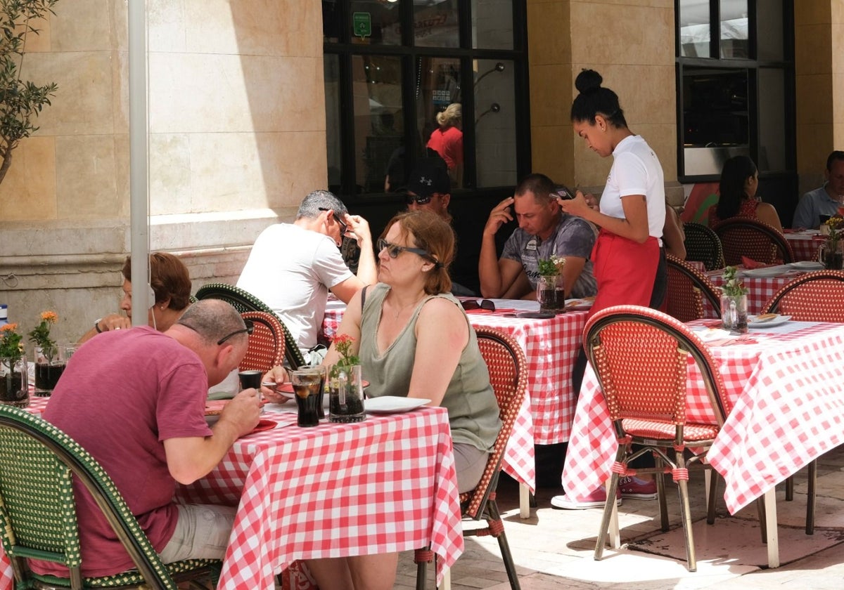 Customers being served at a restaurant in Malaga city centre.