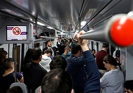 Passengers on board a packed Cercanías train on the Costa del Sol.