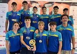 The swimmers pose with their medals.