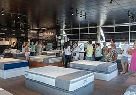 Customers queue for a mattress.