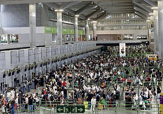 File image of passengers queueing up to check in at Malaga Airport.