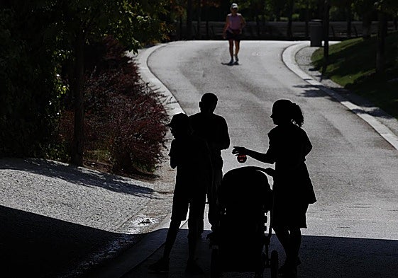 A family out walking sensibly seeks some shade during a heatwave n Spain.