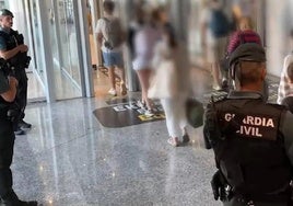 Guardia Civil officers control the departure of passengers from Loiu airport.