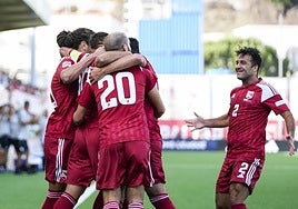 Captain Liam Walker celebrates a goal with teammates.