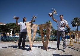 The winning team at the El Palustre masonry competition, next to their work.