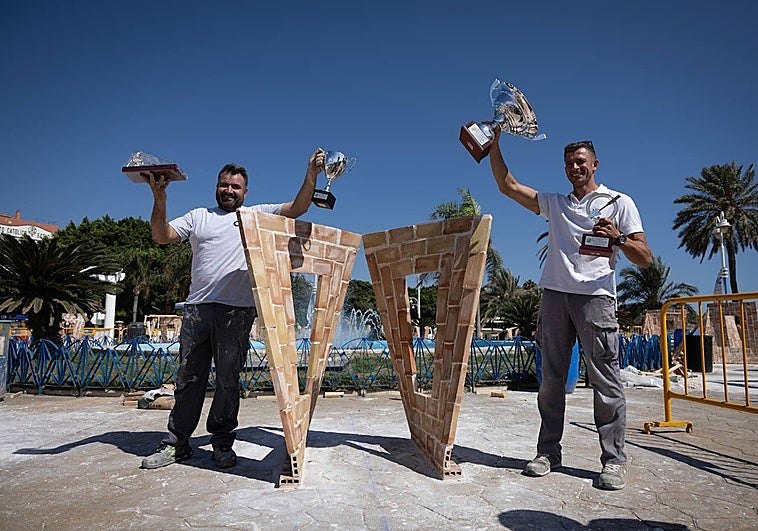 The winning team at the El Palustre masonry competition, next to their work.