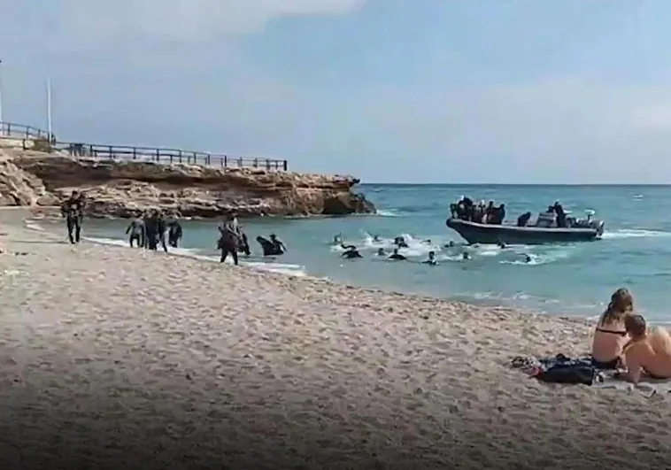 The moment the boat dropped the migrants on the shore before speeding off.