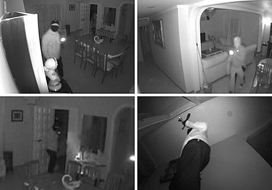 Security cameras capture two hooded men, wearing gloves and carrying torches, inside a property.