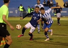 Marbella's José Callejón tries to hold a defender off.