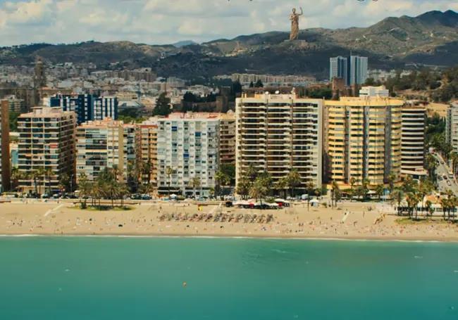 Photo of La Malagueta beach, with a statue of Zeus on Monte Coronado in Malaga in the background.