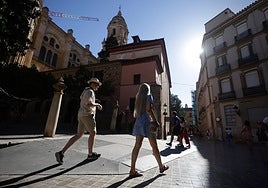 Tourists stroll through Malaga city centre.