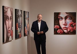 Fernando Núñez poses next to some of his works.