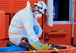 A rescue worker attends to one of the migrants.