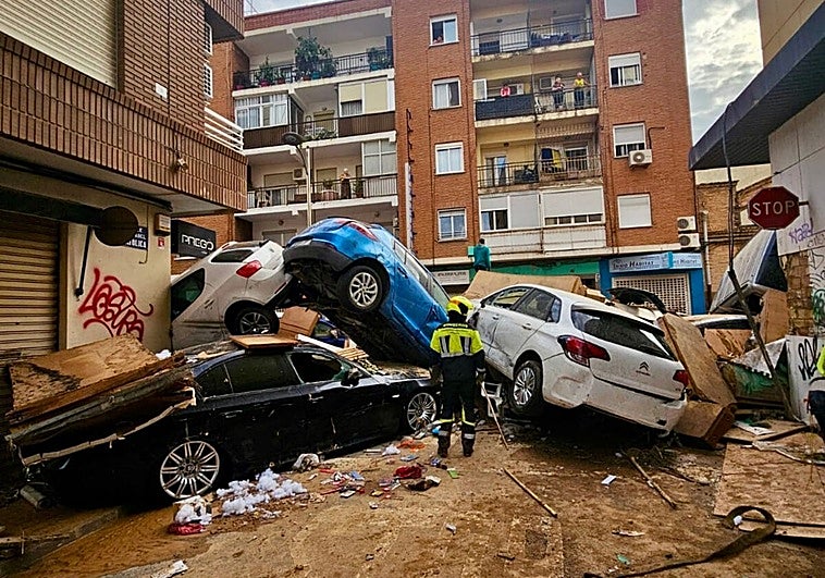 Firefighters from Malaga search for victims among a mountain of twisted vehicles after the 'Dana' storm caused a huge loss of life in Valencia.