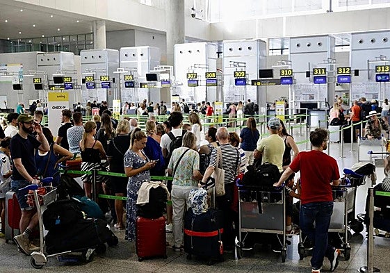 File image of passengers queueing at the check-in desks.