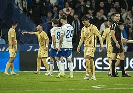 Malaga's Kevin walks off the pitch after his red card.