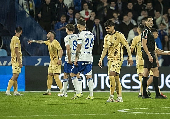 Malaga's Kevin walks off the pitch after his red card.