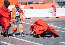 A migrant celebrates making it to the Canary Islands alive after a dangerous sea journey which took several days.