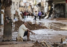 A man observes the damage caused by the floods in the town of Paiporta.