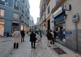 Customers wait their turn to buy their tickets in Malaga city centre.