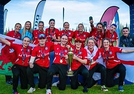 The England XI players pose with the trophy.