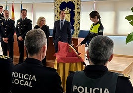 One of the new police officers is sworn in.