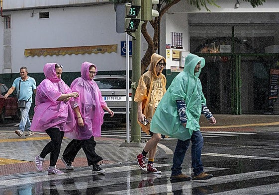 File image of people dodging the rain.