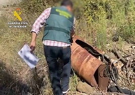A Seprona officer from the Guardia Civil inspects an illegal well in the Axarquia.