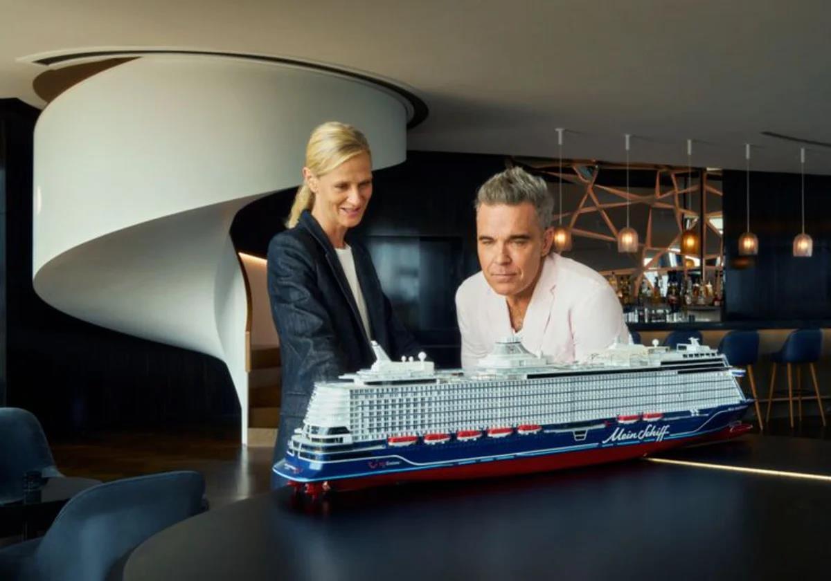 Robbie Williams next to the model of the cruise ship he will be 'christening' in Malaga.