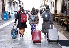 File image of tourists trundling suitcases in Malaga city centre.