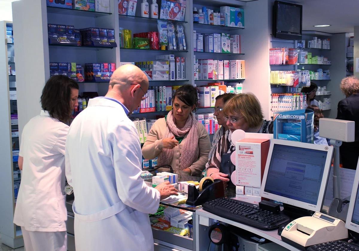 Pharmacists busy attending to several customers.