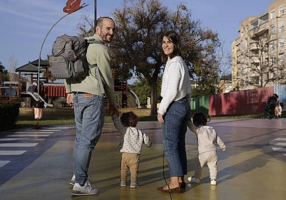 Rocío Reina strolls with her partner and her two 18-month-old children, who she had after beating breast cancer.
