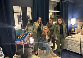 The staff at Bdhome with one of the exclusive chairs.