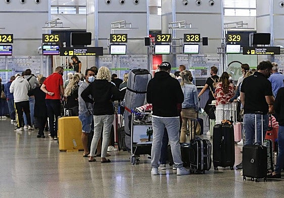 File image of passengers waiting to check in their luggage.