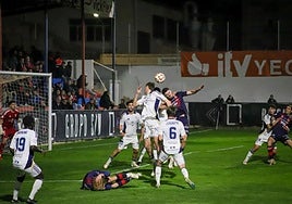 An aerial duel in the Marbella penalty area during Friday's clash.