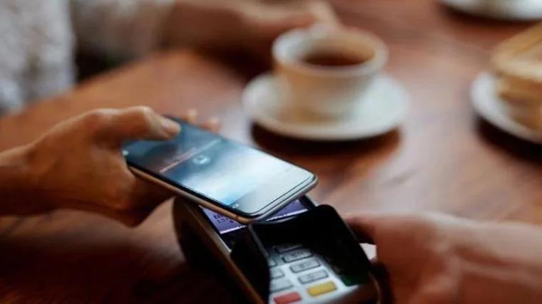 Many people carry their debit cards integrated into their mobile phones to pay in shops.
