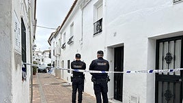 Police officers outside the property.