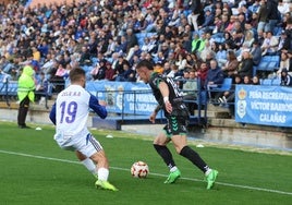 Antequera's Elejalde attempts to dribble past Recreativo's Zelu.