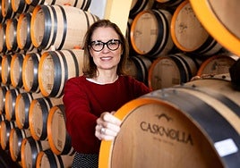 Marta Suárez, manager of Quitapenas, standing by the wine barrels in the bar's cellar.