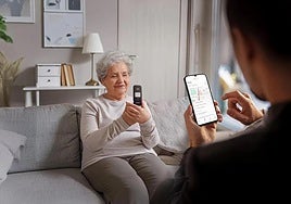 A woman uses one of SPC's mobile phones made especially for seniors.