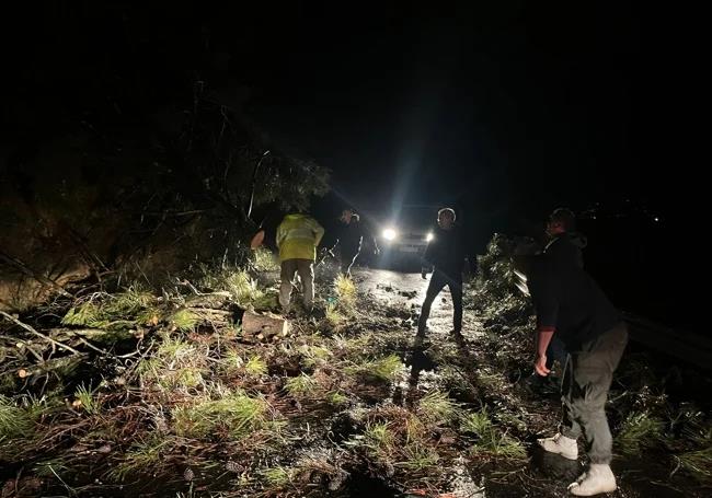 Workers clearing the road between Igualeja and Pujerra at dawn.