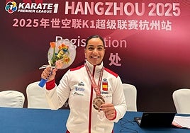Torres poses with her medal.