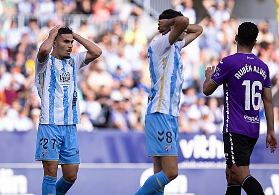 Malaga's Chupete and Juanpe react to a missed chance.
