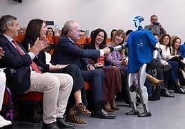 One of the robots, G-1, on the opening day of the international conference, greeting Malaga's mayor.